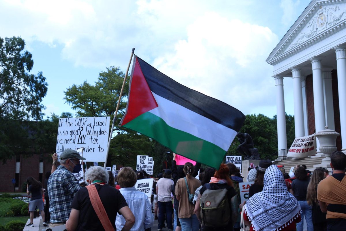 Community+members+gathered+around+Grawmeyer+Hall%2C+waving+Palestinian+flags+during+the+Nakba+rally.+