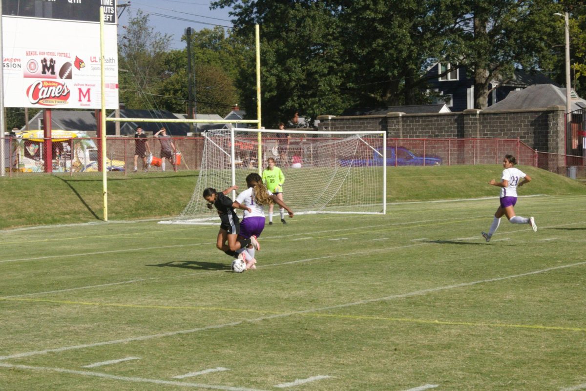 Isabella Acosta (#16, 9) battling for the ball.