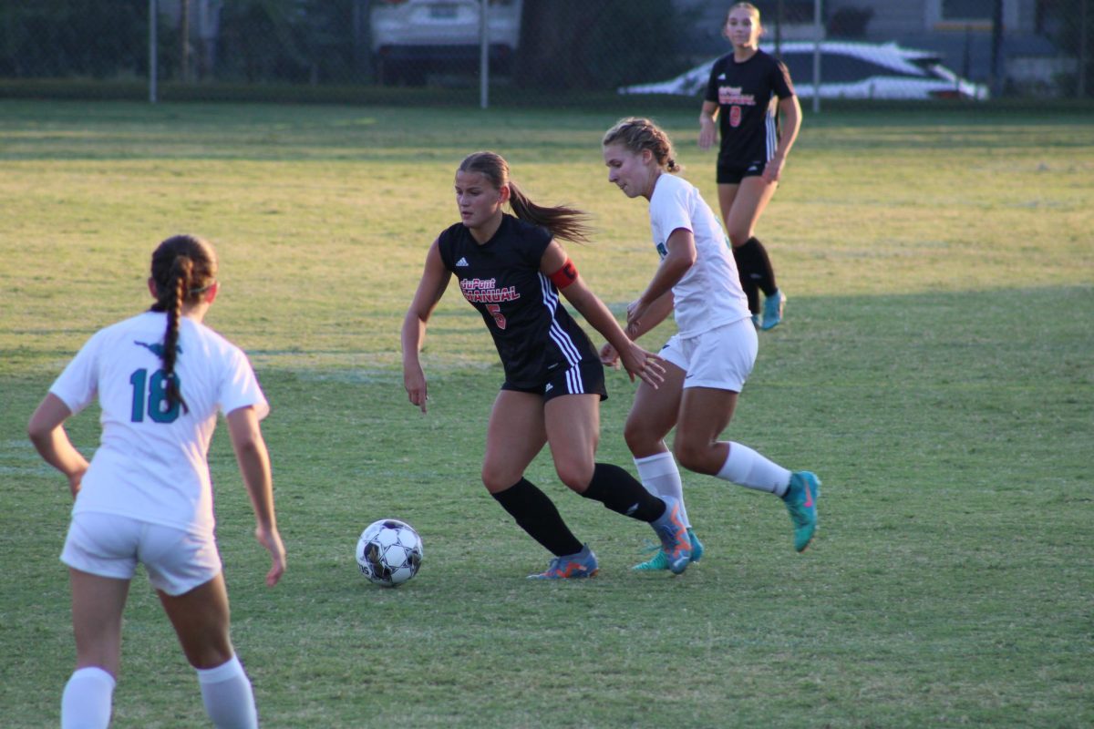 Chloe Groemling (#5, 11) takes on a couple of Mustang defenders.