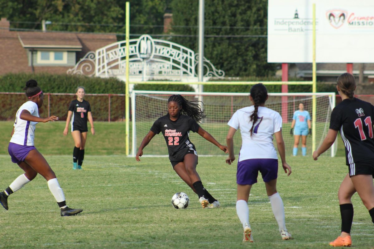 Jasmine Smith (#22,11) takes the ball through the midfield during the match against Male.