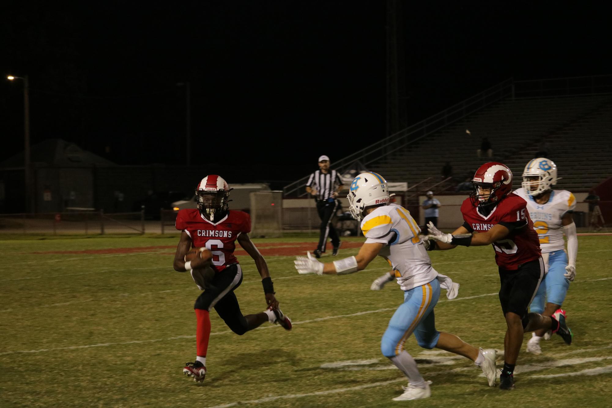 Kaden Mack (#6, 10) tries rushing past a Central Hardin player. 