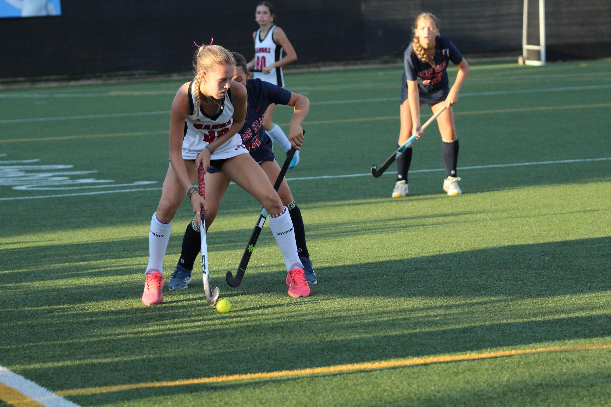 Brynn Powell (#48, 10) tries to defend the ball from SHA.