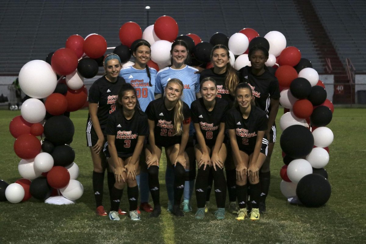 The senior girls pose for a picture, concluding their senior night. 