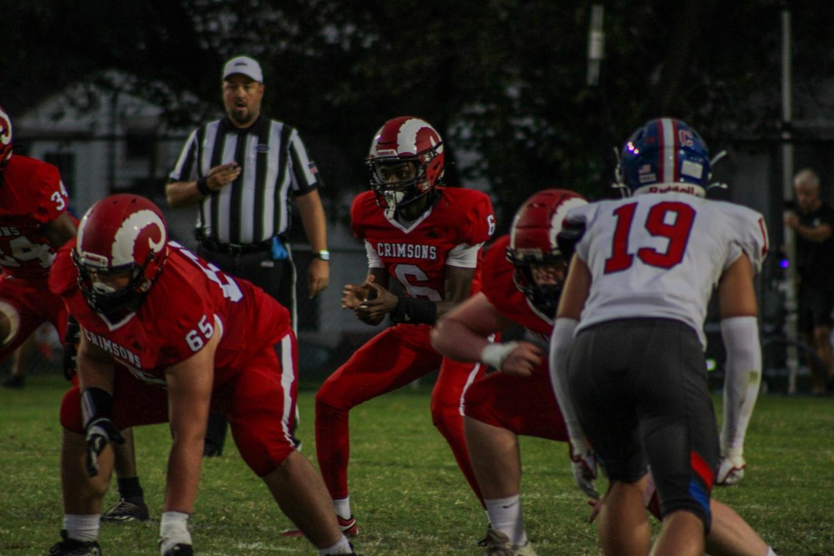 Kaden Mack (#6,10) claps for the snap.