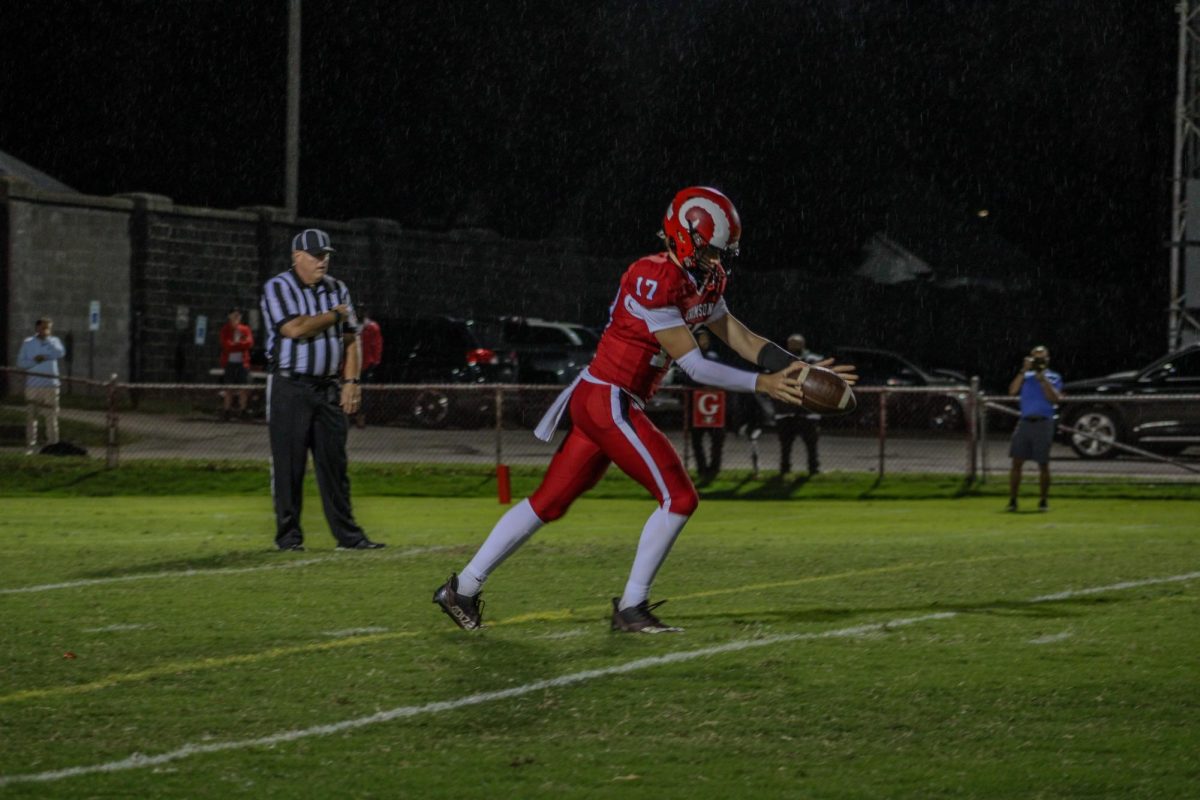 Jackson Pritts (#17,10) holds the ball out to prepare for punt.