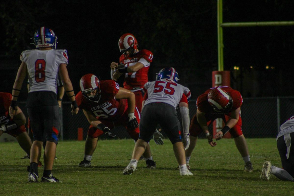 Jackson Pritts (#17,10) checks his wristband for the play call.