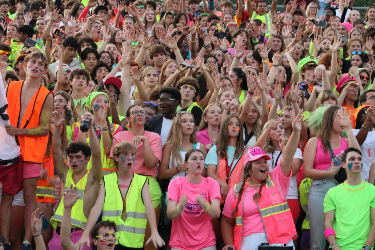 The student section cheers on the football team from the sideline. 