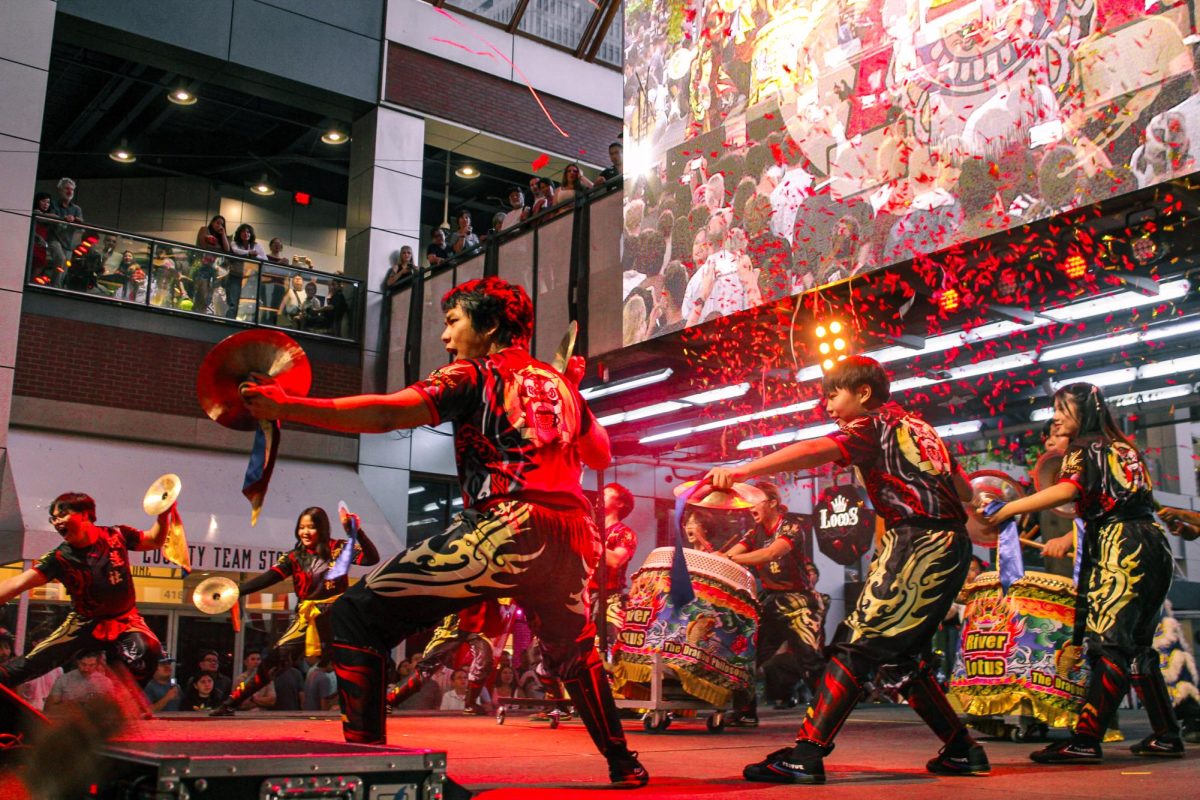 River Lotus Lion Dance group performs a dance with drummijg and chanting on the main stage at Fourth Street Live.