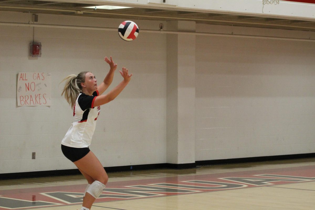 Aubrey Montgomery (#29, 12) prepares to serve the ball. 