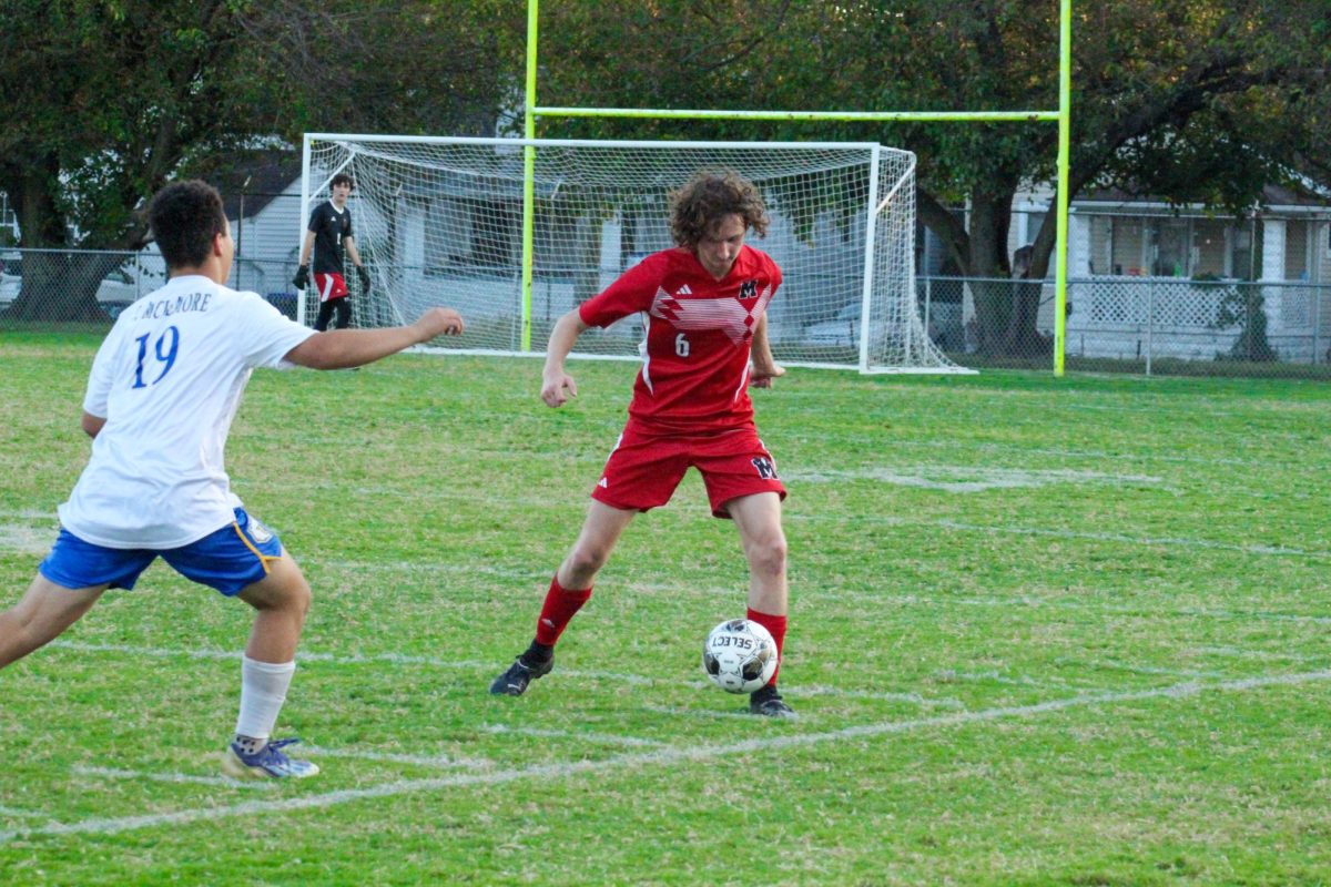 Rhyse Johnston (#6, 12) dribbling the ball up against Brown defender. 