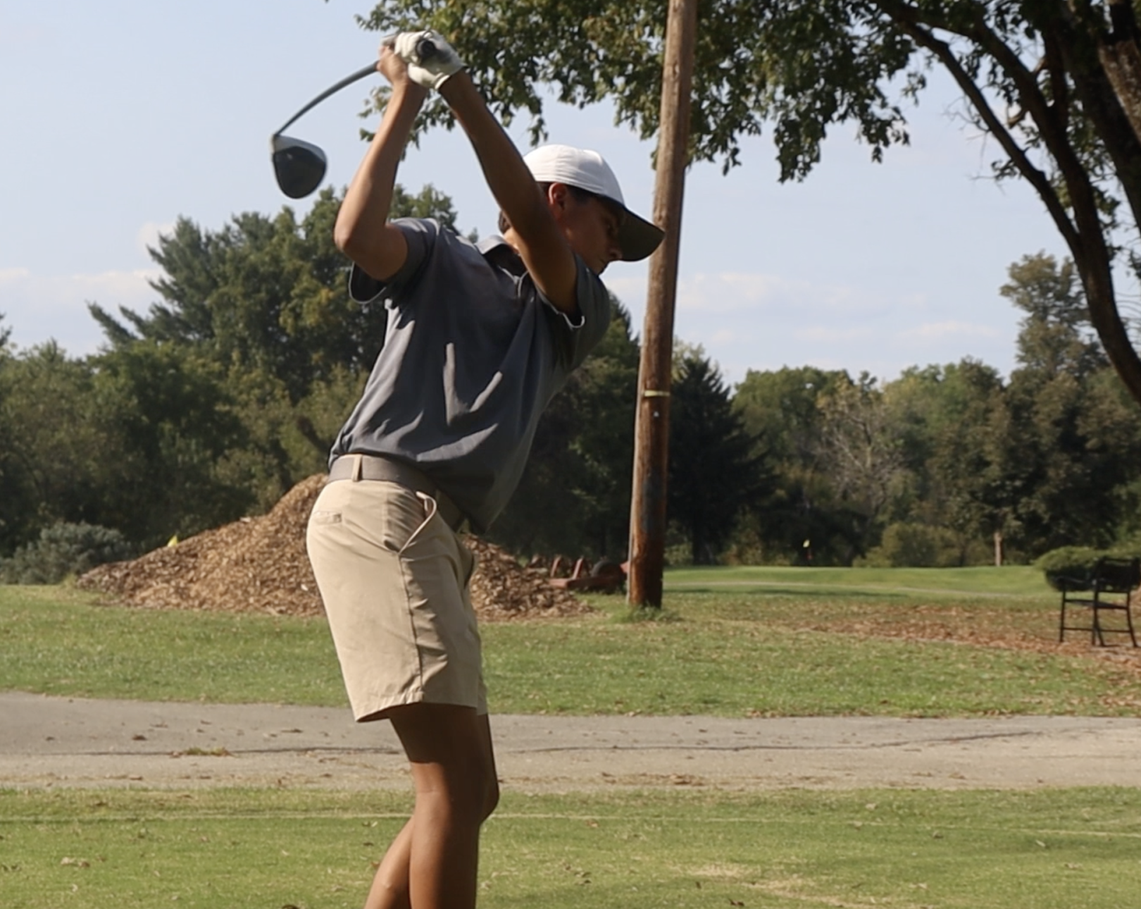 Daniel Abrams (12, HSU) swings through his drive on the second hole. 