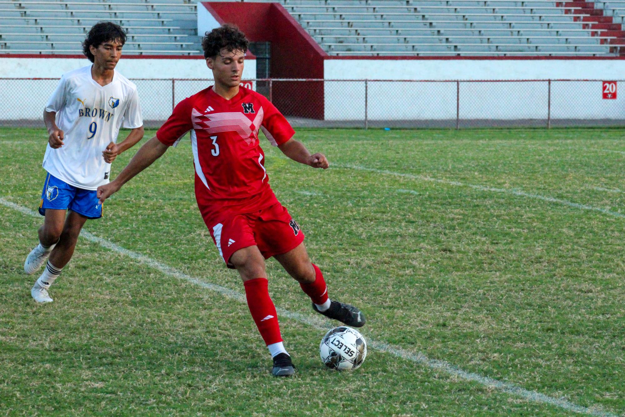 Taysir "Tito" Khatib (#3, 12) passing the ball up the field.