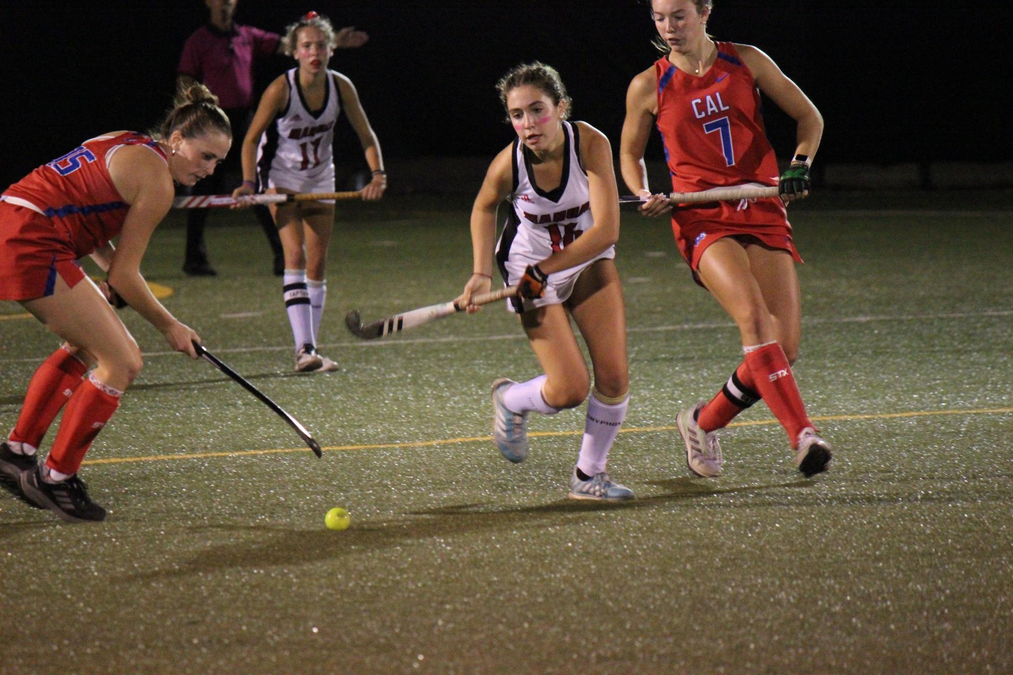 Stella Shuman (#16, 10) tries to take the ball surrounded by CAL players.