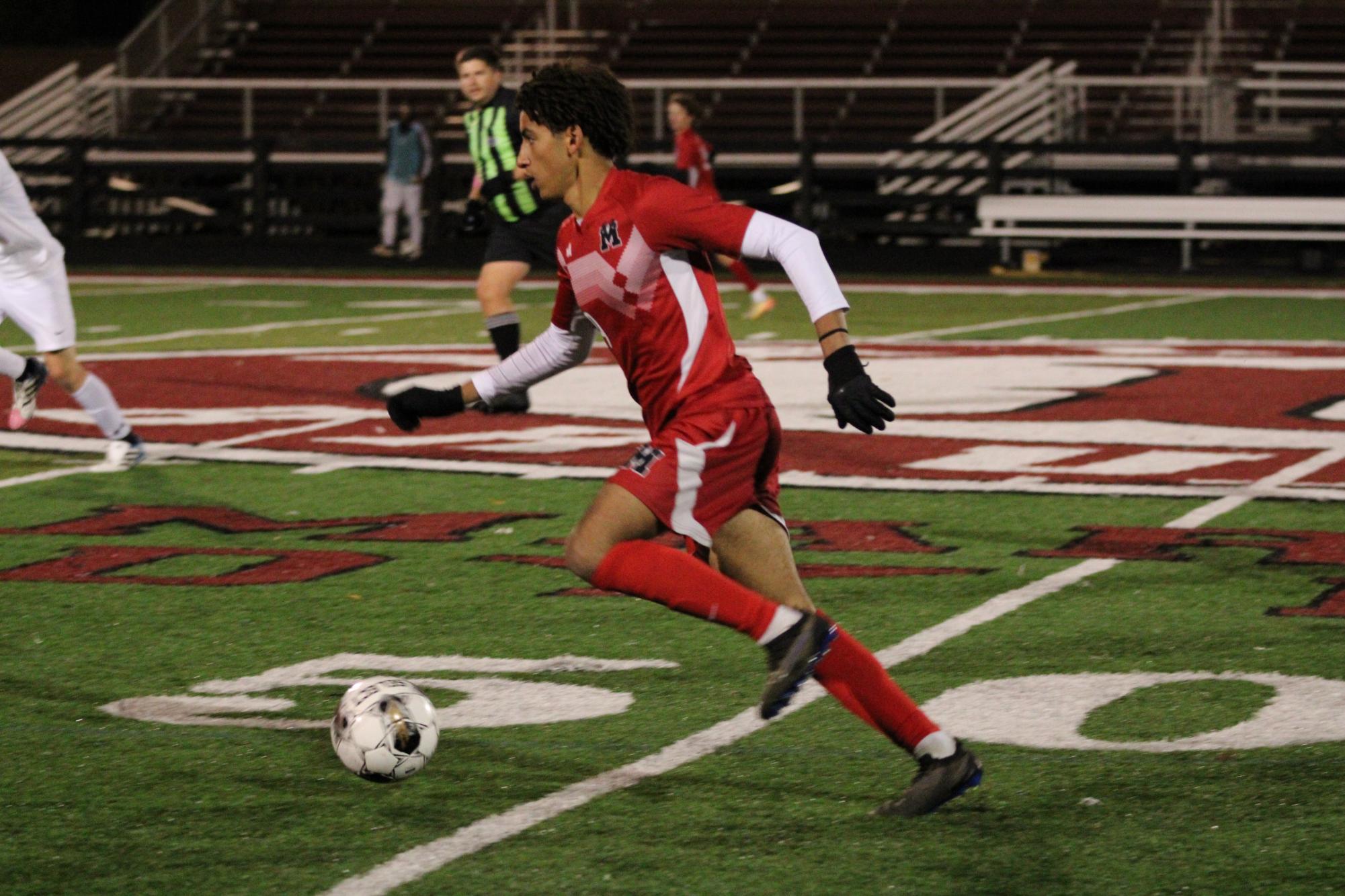 Yassin Mohamed-Hassan (#19, 12) dribbles the ball down the field. 