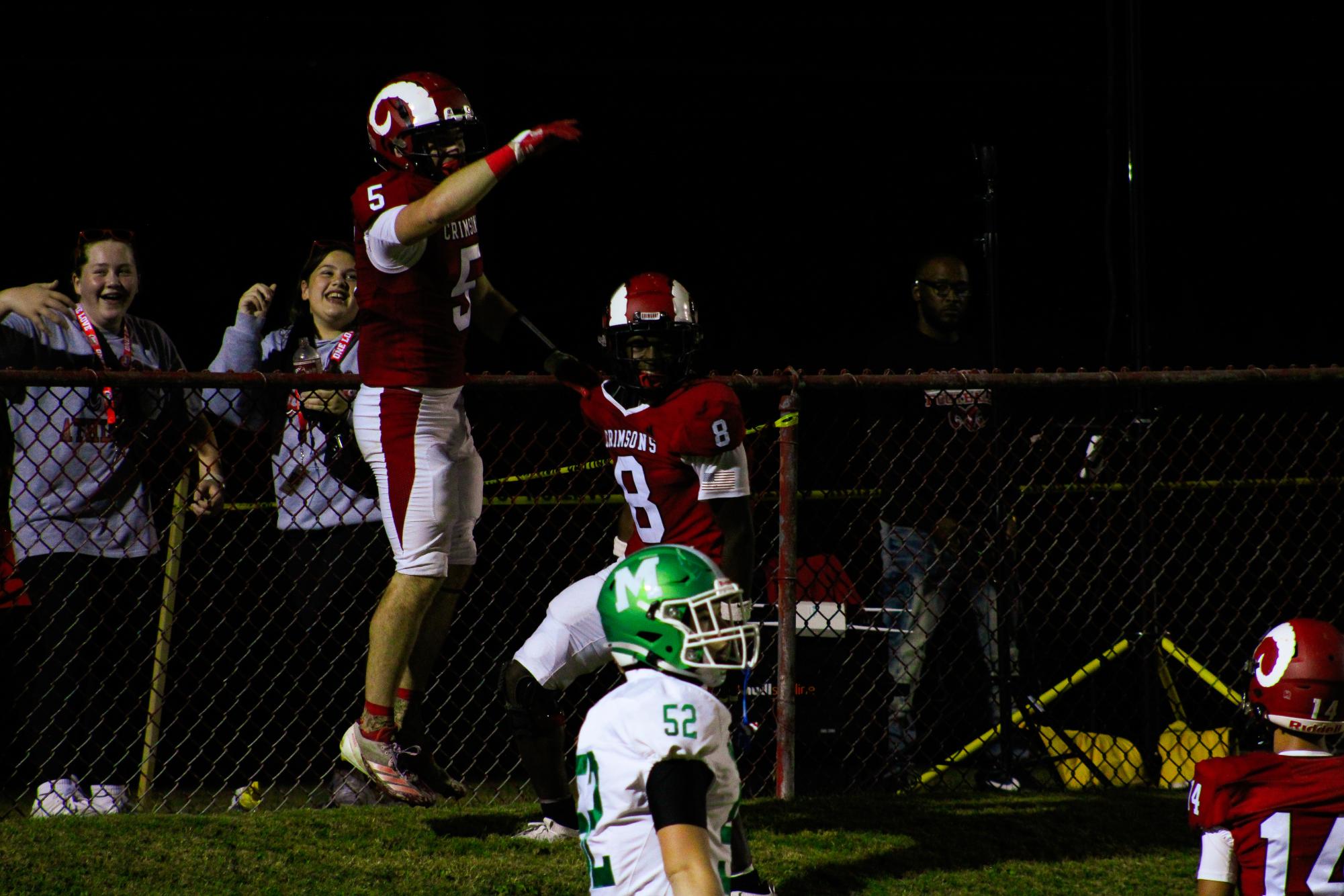 Willis Nofinsger (#5, 12) and Aiden Blakey (#8, 12) celebrate after scoring a touchdown on the hill.