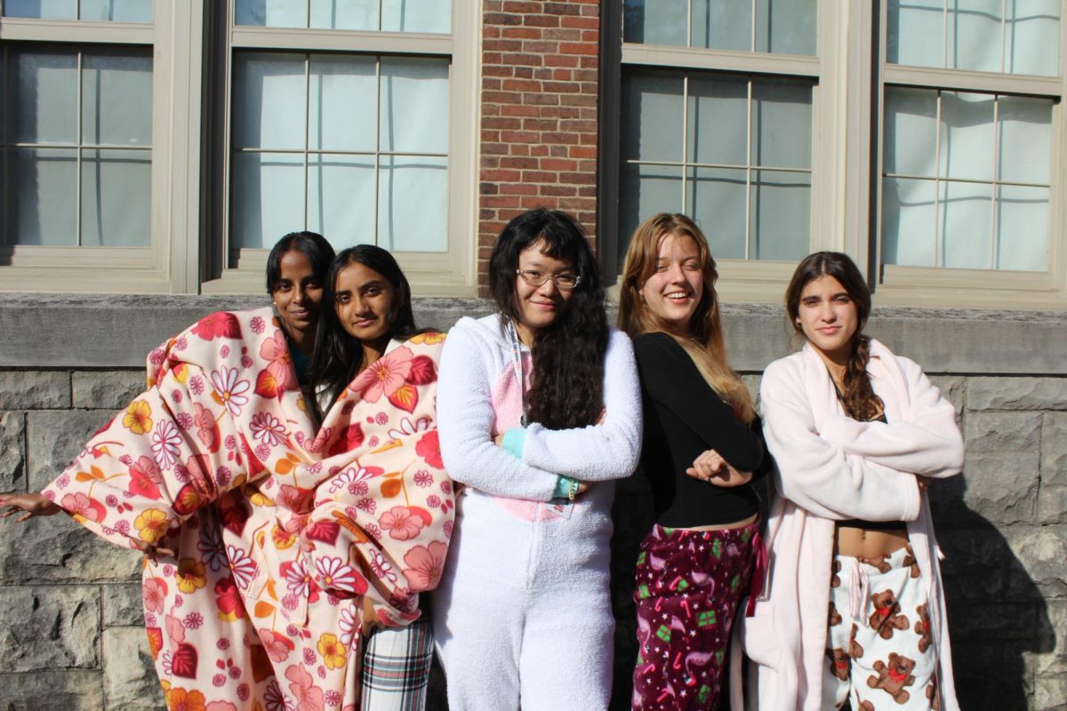 A group of students enjoy the courtyard weather in their pajamas