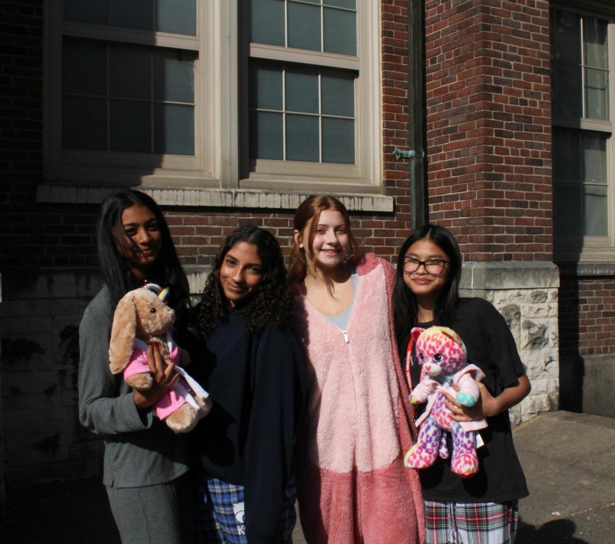 A group of students pose with their stuffed toys