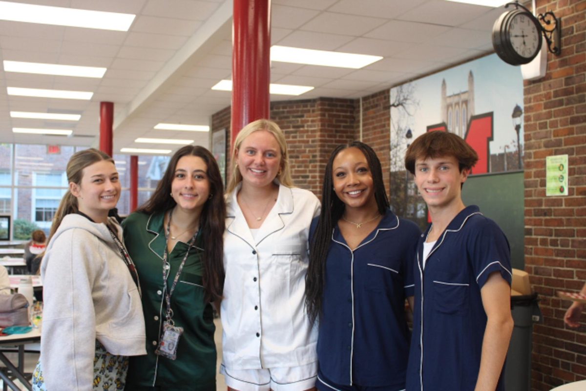 A group of students pose with their satin pajamas sets