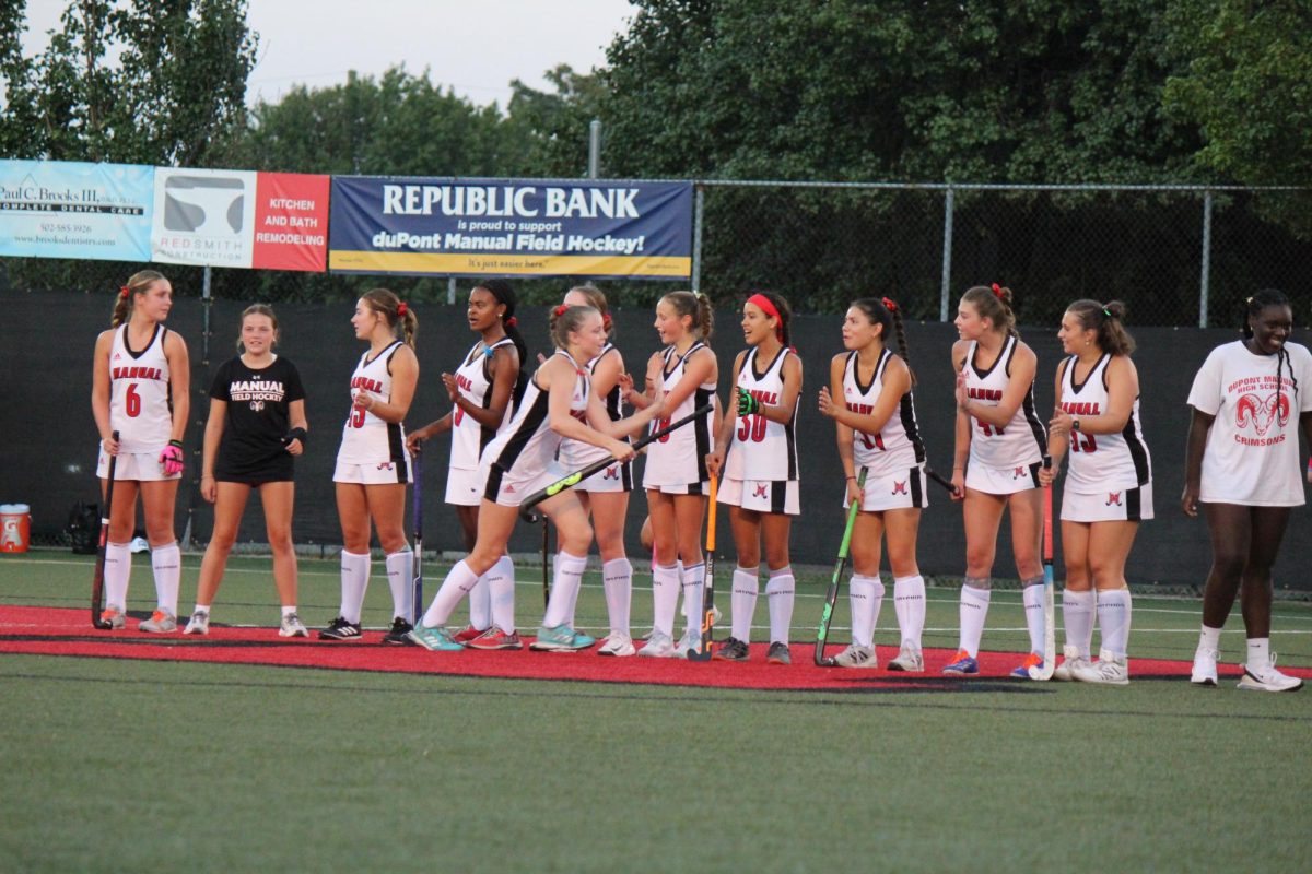 Members of the varsity field hockey team stand on the sideline for player introductions prior to the start of their game against South Oldham. 