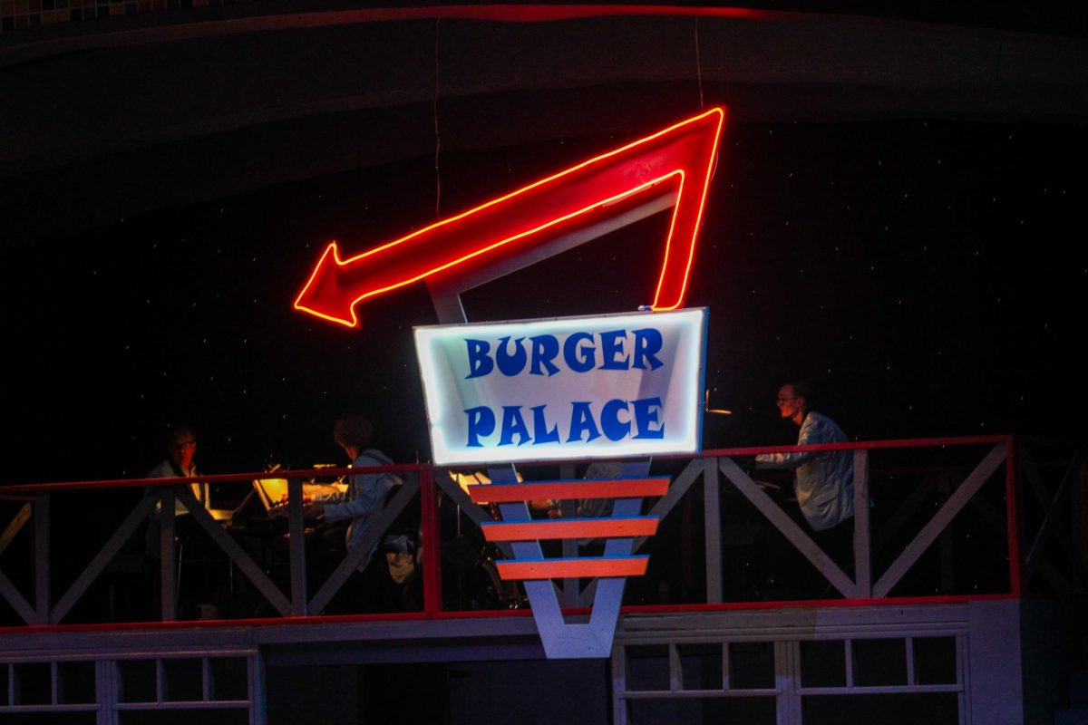 The illuminated ‘Burger Palace’ sign hangs during the musical.