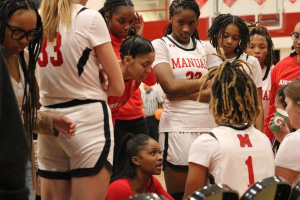 Head coach Ashley Franklin talking to the Lady Crimsons during a timeout.