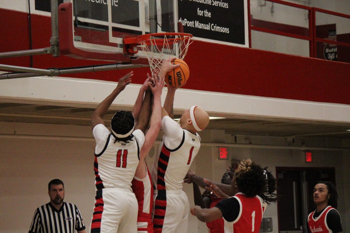 Manual's Justice Decker (#1, 12) and Ahmad Shelton (#11, 11) fighting for the rebound.