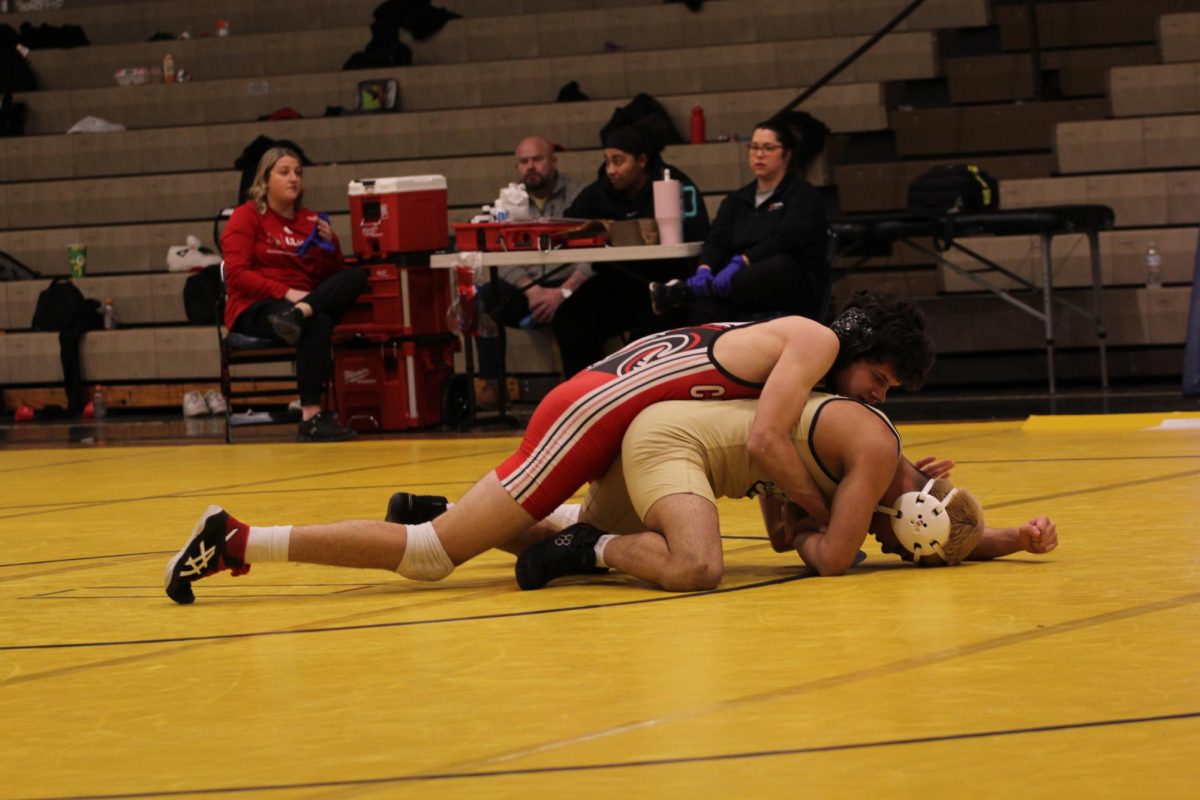 Will Jeziorski (12, HSU) wrestles his opponent.