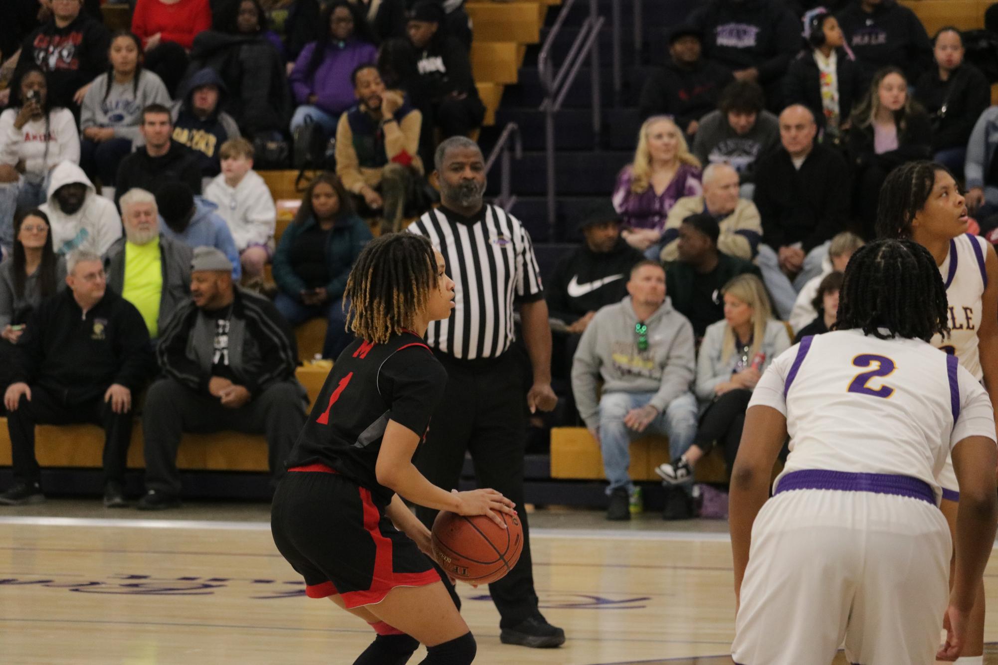 Takenzie Young (#1, 9) gets ready to shoot her free throw.