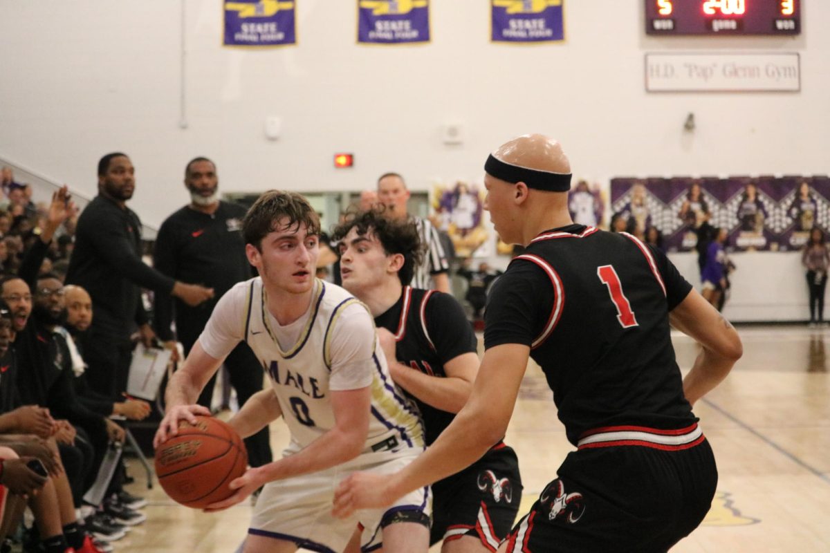 Justice Decker (#1, 12) and Noah Smith (#2, 12) work together to block Male's Cole Edelen.