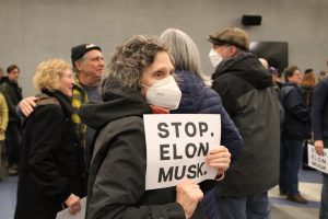 Signs reading "STOP ELON MUSK" were displayed throughout the rally.