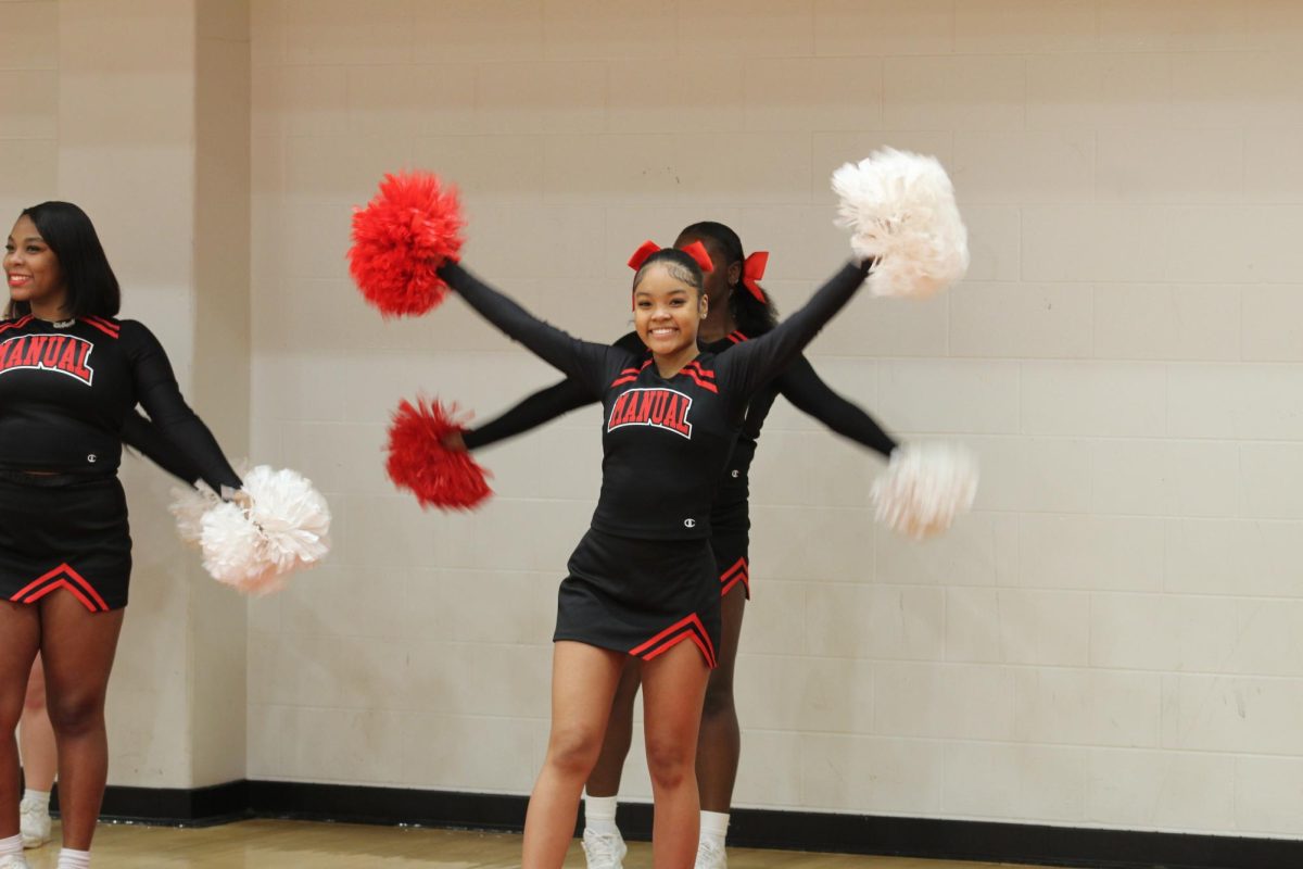 The cheerleaders smile enthusiastically and cheer on Manual during the game. 