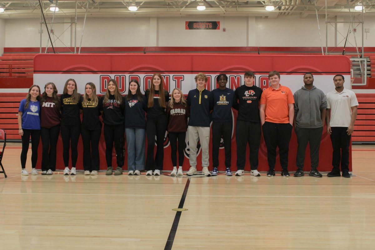 15 Manual seniors pose together to celebrate their signing day. 