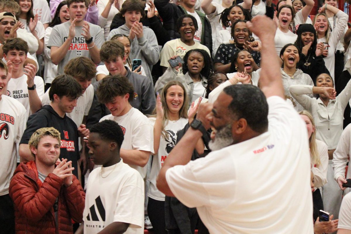 Coach Coleman celebrating with Manual's student section after the game.