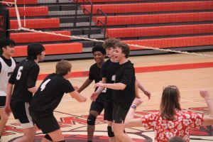 Manual players celebrate after winning a point. 