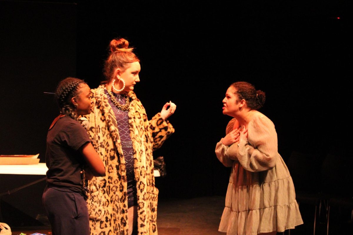 Timyah Hall (11, YPAS) and Sadie Eichenberger (11, J&C) converse with Maya Williamson (11, YPAS) on stage. Photo by Lydia Adams.