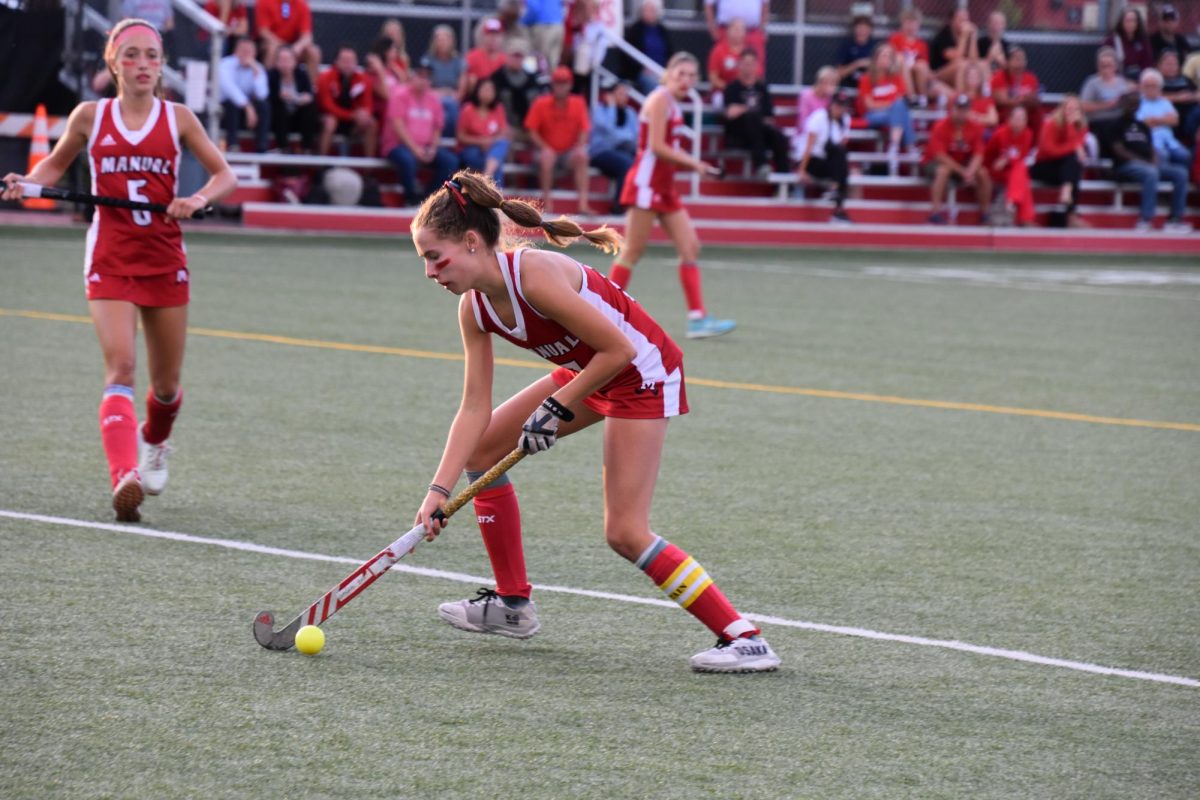Charlotte Connally (#17, 12) prepares to pass the ball to her teammate.