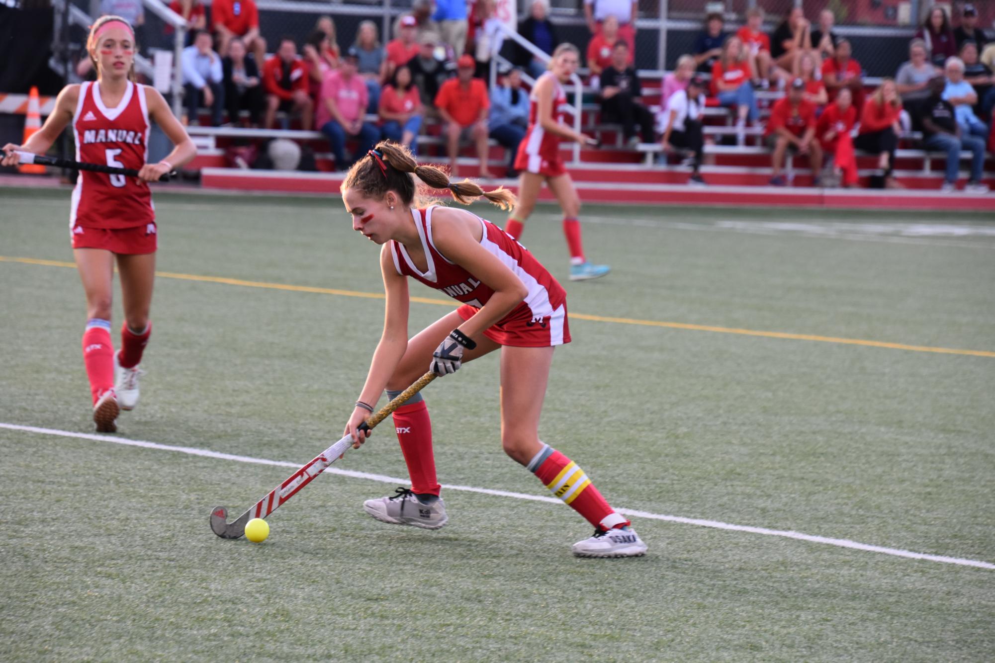Charlotte Connally (#17, 12) prepares to pass the ball to her teammate.
