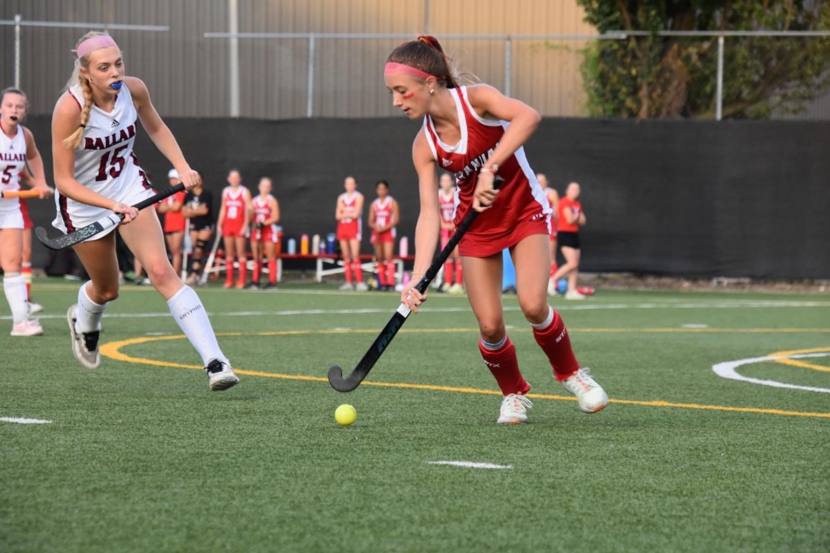 Forest Faversham (#5, 9) keeps the ball away from a Ballard player.