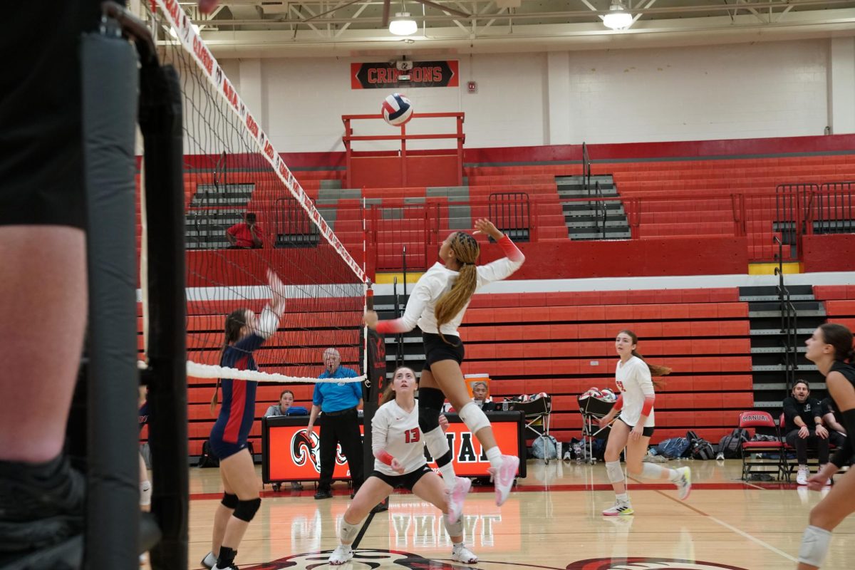 Nadia Bishop (#7, 12) prepares to make a heavy spike on Francis Parker.