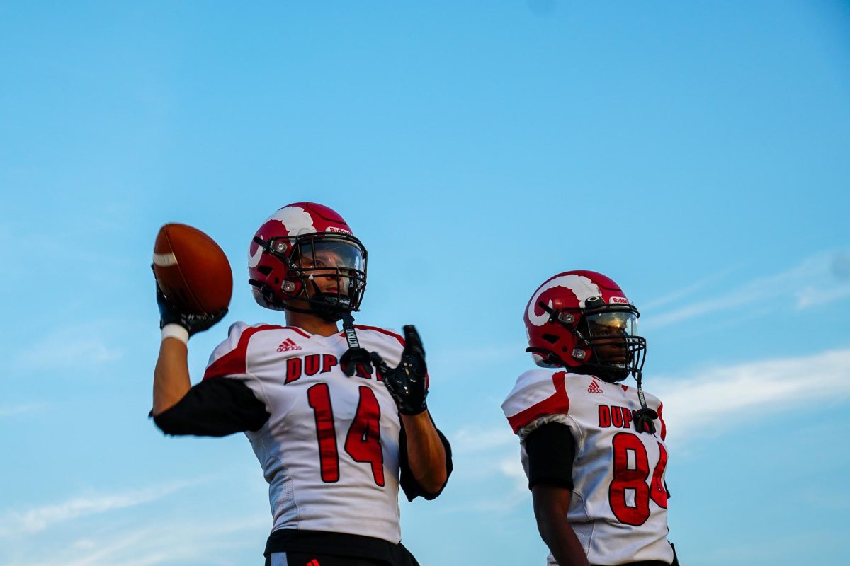 Brayland Miles (#14,11) and Darion Cole (#84,11) warm up before the game against Cooper.