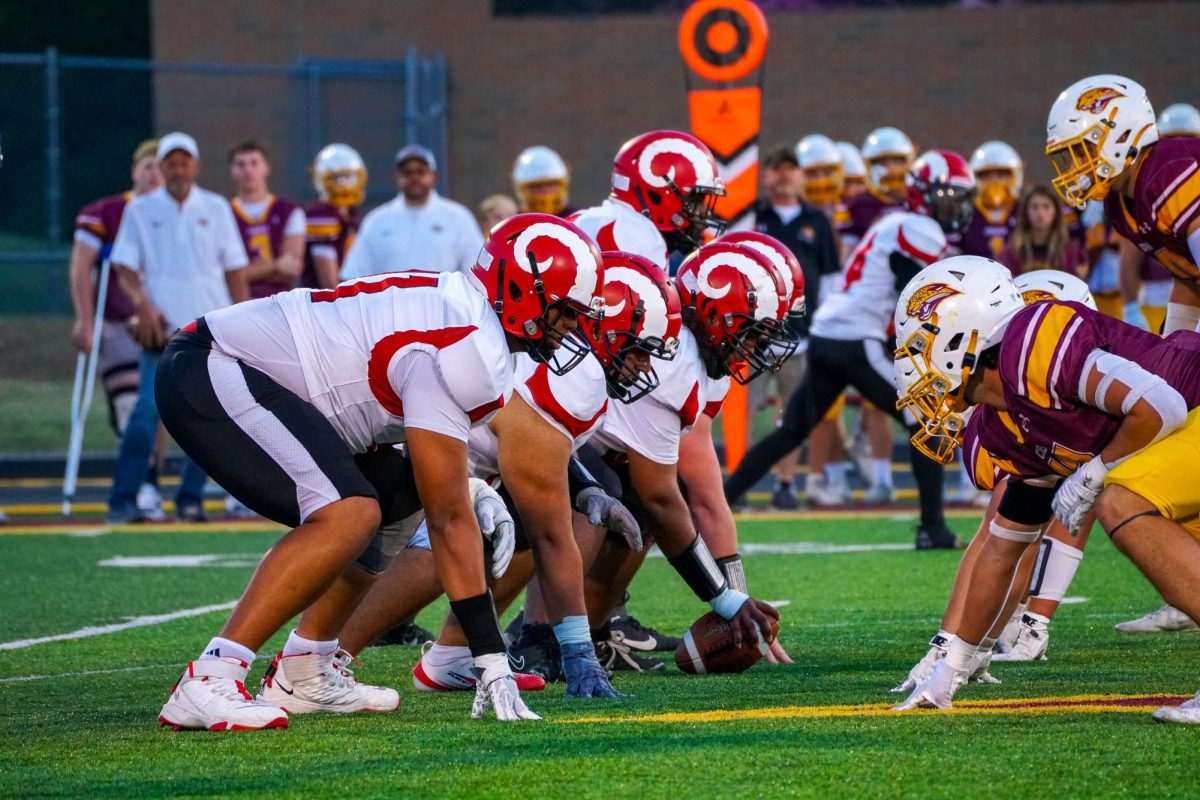 Dupont Manual offensive line preparing to snap the ball.