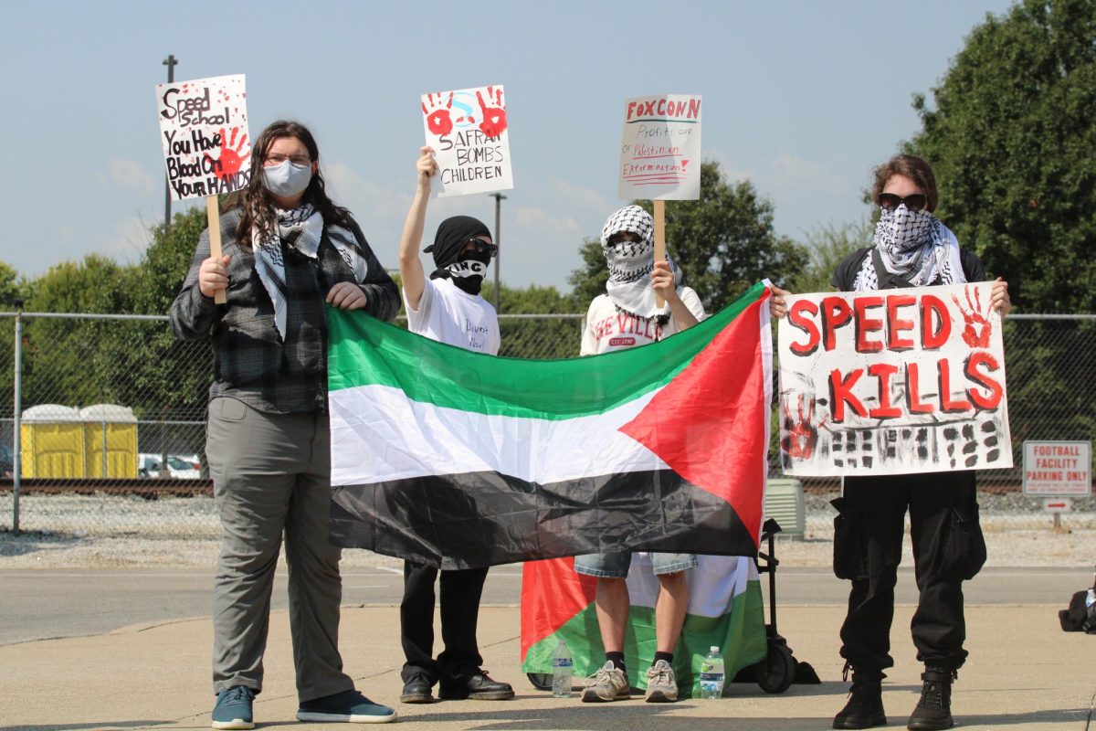 Group of LSJP members in front of UofL’s Speed School for Engineering protesting against the career fair and the companies that UofL hosted there.