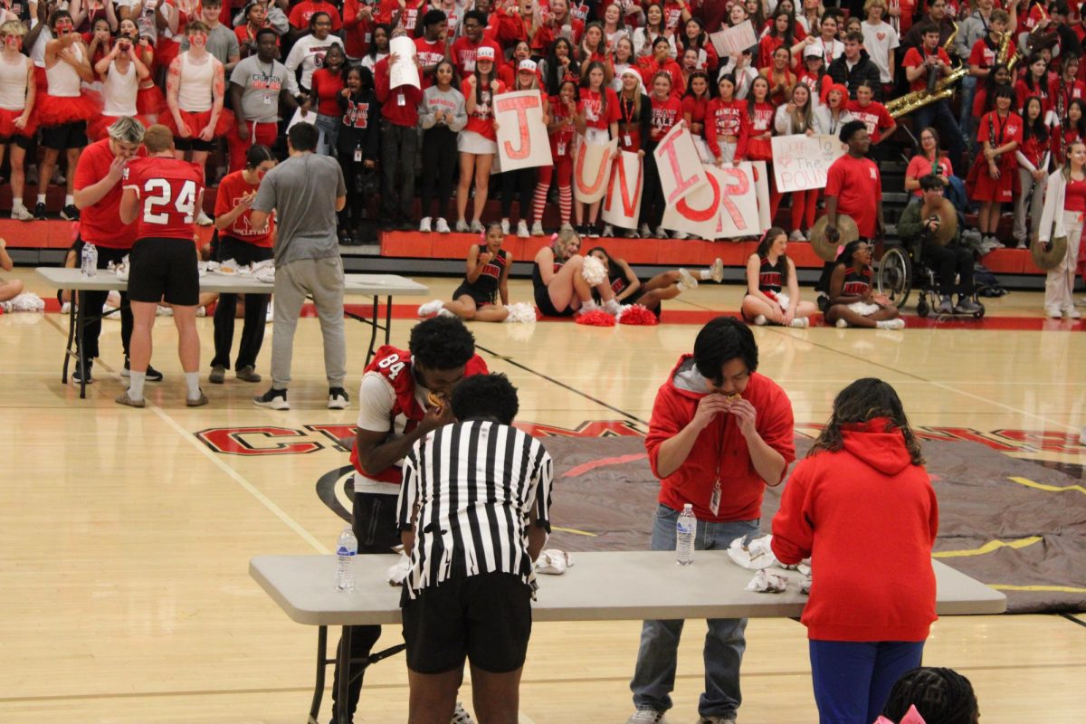 Students eat as many burgers as possible for the eating competition.
