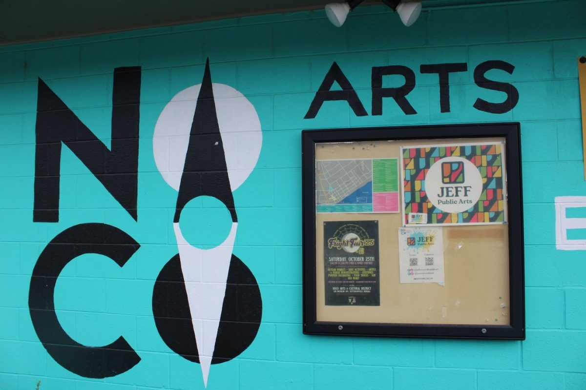 A bulletin board outside the theatre advertises events happening in the NoCo Arts and Cultural District.