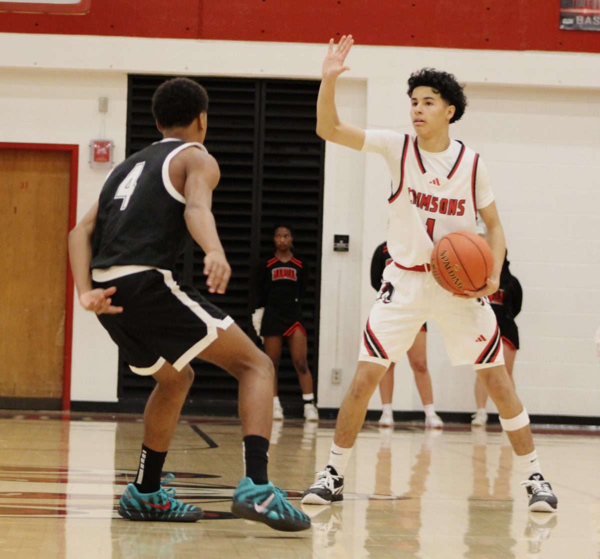 Dario Harper (#1,10) pushes the ball up the court, scanning the defense.