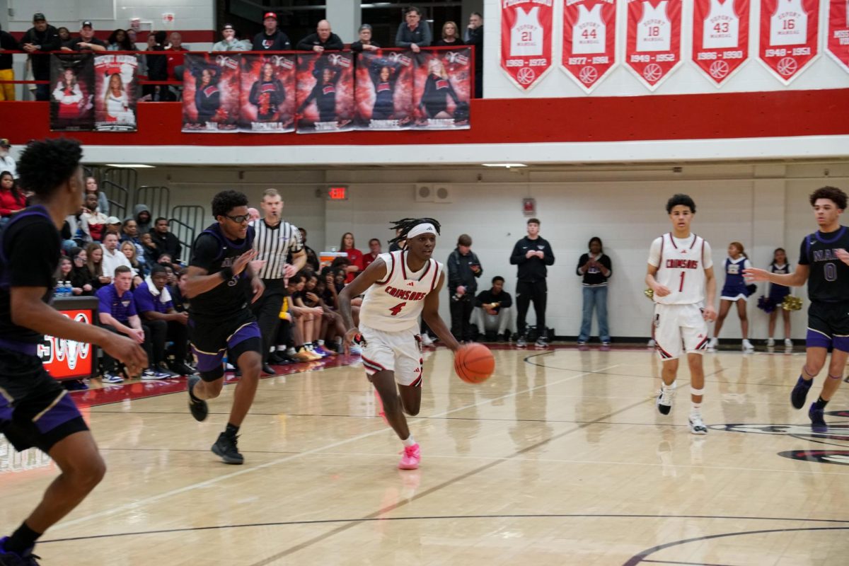 Geoffrey Njogu (#4, 12) Dribbled past a Male player making a run for the basket.