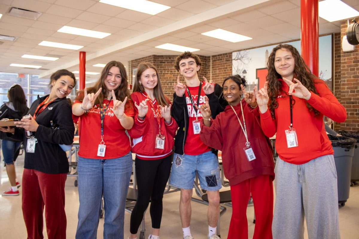 A group of seniors pose in their red spirit wear.