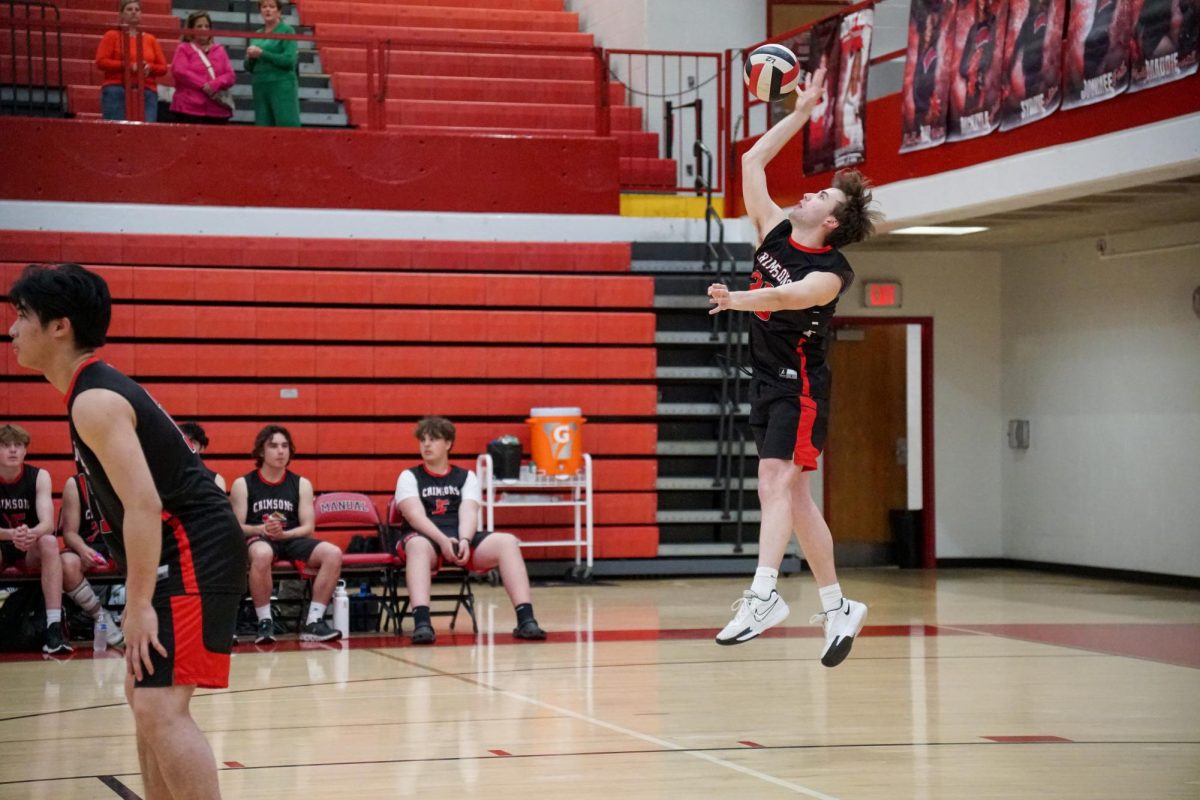 Luke Boggs (#20,12) serves the ball in the first set. 