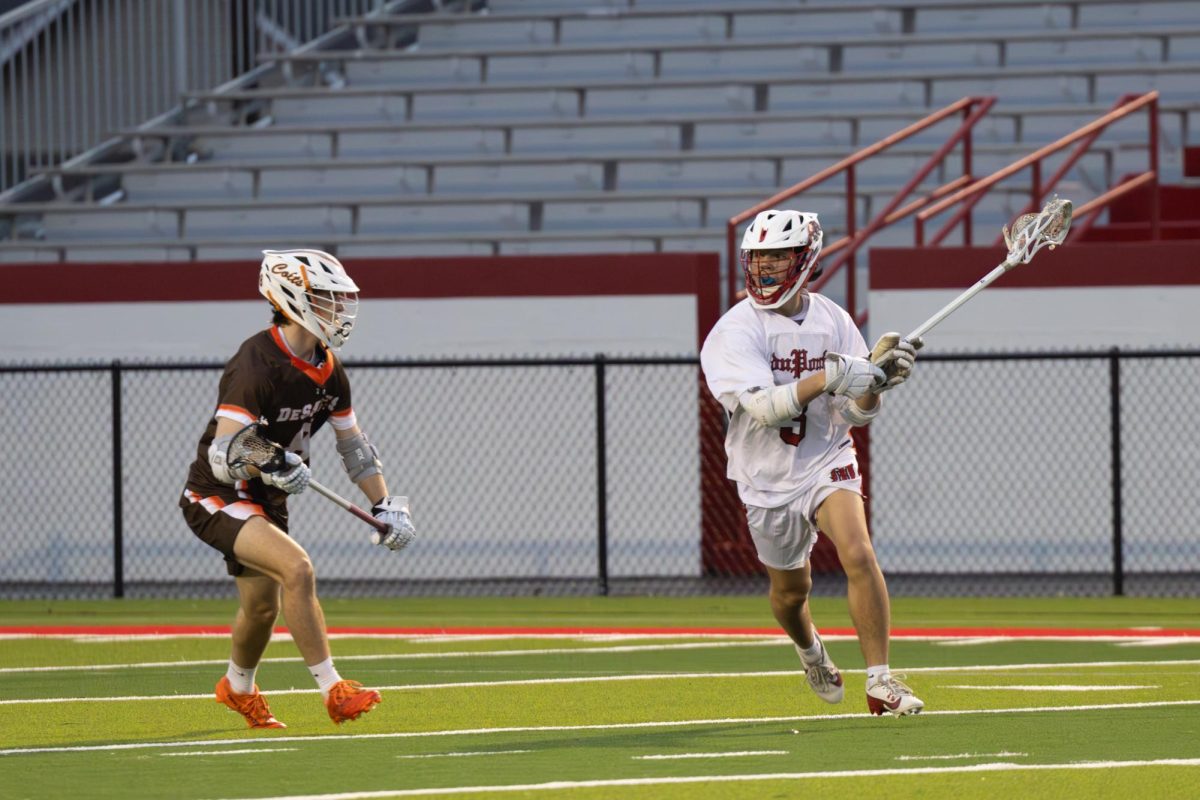 Roehn Dye (#3, 11) looks to pass while DeSales defender closes in, searching for an opening during the first half.