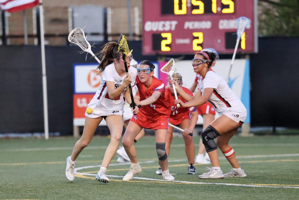 Sophie Habeeb (#20, 11) and Sarudzai Charasika (#11, 12) battle CAL for possession of the ball.